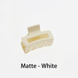 Detail of matte cream white rectangular hollow hair claw clip with strong metal spring
