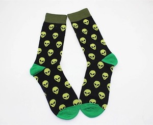 Detail of crew socks featuring alien patterns with olive cuffs and green heels