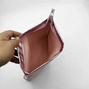 Detail view of pink PU leather makeup bag showing interior lining and silver zipper