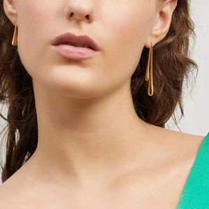 Minimalist gold teardrop earrings for women shown as a pair on a professional model