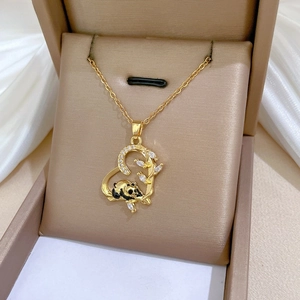 Detailed view of heart panda pendant with gold plating and cubic zirconia on a jewelry box