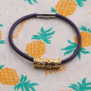 Fashionable purple leather bracelet with gold hollow metal charms and magnetic clasp