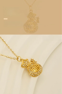 Detailed close-up of 18k gold plated lucky bag pendant necklace with sparkling crystals
