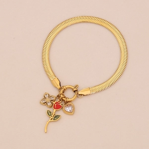 Detail of gold snake chain bracelet with rose, clover, and heart charms featuring an OT clasp