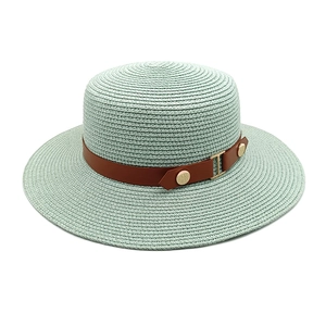 Top view of a light green straw hat with wide brim and brown leather band with gold buckle