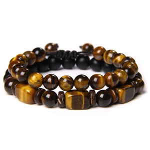 Detailed close-up of tiger eye stone beads and adjustable black braided cord on a bracelet