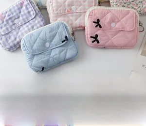 Close-up of quilted mini storage bags with snap buttons and floral patterns