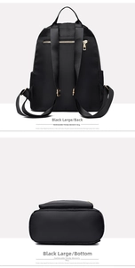 Detail view of large black waterproof oxford cloth backpack showing back straps and sturdy base