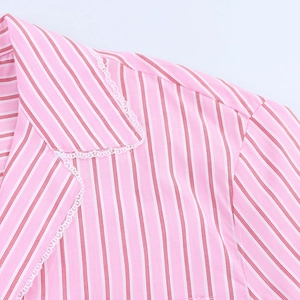 Close-up of pink and white striped blouse featuring delicate white lace trim details