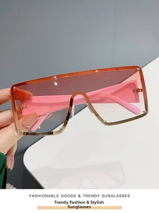 Detail of pink gradient lenses and metal stud rivets on oversized fashion sunglasses