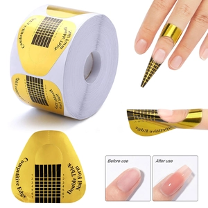 Close-up of golden horseshoe nail forms with precise 1-7 scales for acrylic nail extension