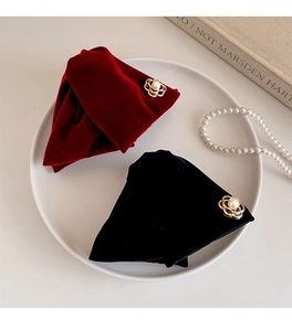Detail of vintage velvet flower hair clips in red and black with pearl gold centers