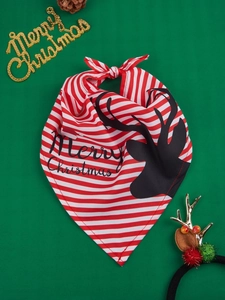 Detail of red and white striped Christmas pet bandana with black reindeer silhouette