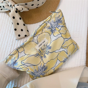 Close-up of floral jacquard makeup bag with zipper and Simple Wish fabric label