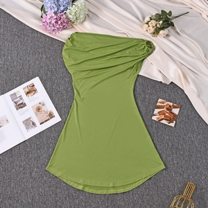 Detailed close-up of grass green off-shoulder dress with elegant pleated neckline texture
