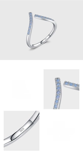 Macro detail of V-shaped S925 sterling silver ring with blue zircon pave setting