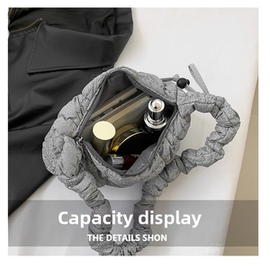 Detailed interior of grey pleated cloud bag showing large capacity for daily items