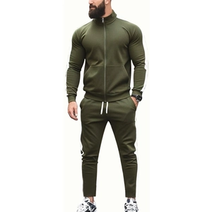 Detail of olive green tracksuit with side white stripes and ribbed elastic cuffs
