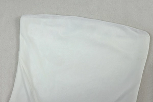 Close-up detail of white double-layer mesh fabric with high-quality stitching on dress