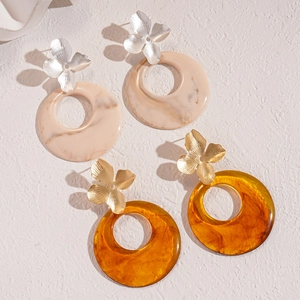 Modern resin hoop earrings with metallic flower studs in beige and amber tones