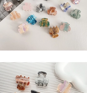 Detail shot of mini acrylic hair claws with marble textures in various elegant colors
