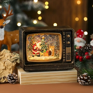 Macro detail of retro TV snow globe lantern with Santa Claus and festive warm lights
