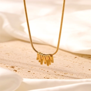 Minimalist gold collar necklace featuring a snake chain and seven sleek bar pendants