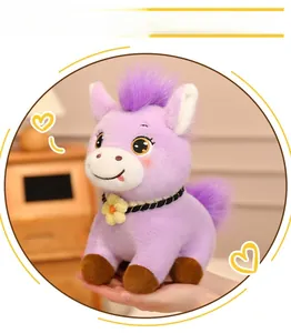 Close-up of a purple plush pony keychain with embroidery eyes and a floral collar