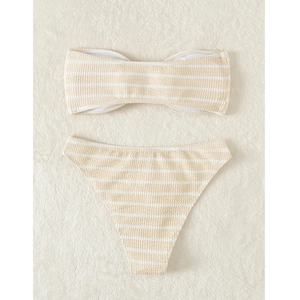 Detail of yellow striped seersucker texture on a strapless bikini set with ribbed fabric