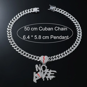 Macro shot of silver Cuban chain with diamond-encrusted NO LOVE heart pendant jewelry