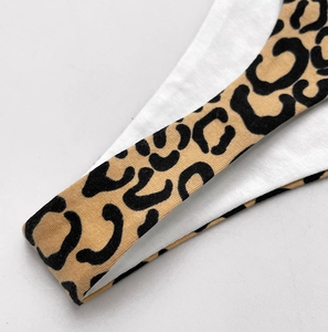Detailed macro view of the soft cotton fabric and classic leopard print on the thong strap