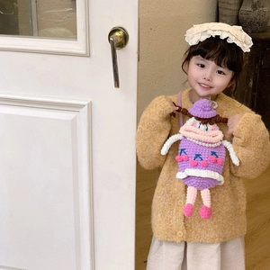 Cute purple knitted cartoon shoulder bag with cherry patterns on a child model
