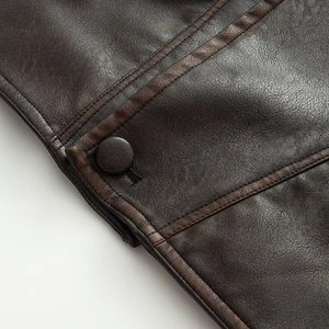 Macro view of dark brown leather texture with detailed stitching and matching buttons