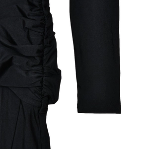 Detailed view of the black ruched fabric texture and long sleeve design on the dress