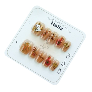 Cute New Year press-on nails with cartoon cat and orange patterns on a white display card