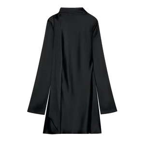 Macro detail of the premium silky satin texture and elegant draped neckline on the black dress