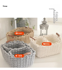 Detail of woven cotton rope storage baskets with leather handles in brown, white and grey