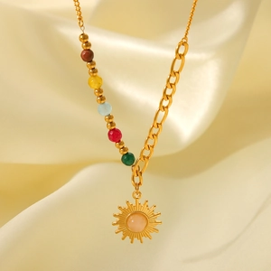 Detail of 18K gold stainless steel sun pendant necklace with colored beads on satin