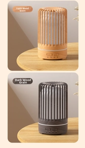 Close-up of birdcage diffuser with light and dark wood grain finishes and timer buttons