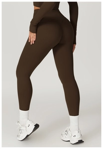 Detail of high waist dark brown yoga leggings with matte elastic fabric and push-up effect