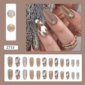 Retro oval brown press-on nails set with floral art, silver glitter and tiny rhinestones