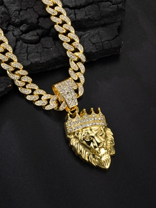 Close-up of gold lion head crown pendant with sparkling rhinestones on cuban chain
