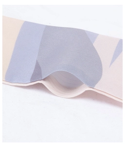 Close-up of the knitted fabric texture and colorful pattern of the long skinny scarf