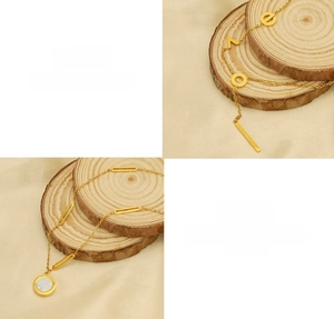 Detail of titanium steel gold necklaces with LOVE letters and mother of pearl pendants