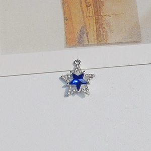 Detailed view of pentagram pendant with blue star crystal and white rhinestone micro-pave