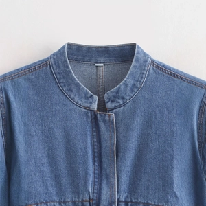 Short blue denim jacket for women featuring contrast stitching and a round neckline