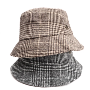 Close-up of vintage plaid wool bucket hats in various colors with metallic accents