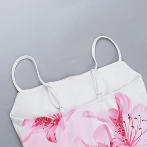 Close-up of adjustable spaghetti straps and floral print on a summer crop top