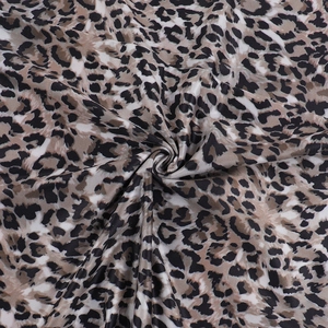 Detailed macro shot of elegant leopard print fabric showing soft texture and drape