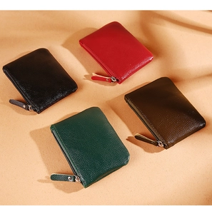 Detailed view of four colorful lychee textured PU leather coin purses with zipper closures